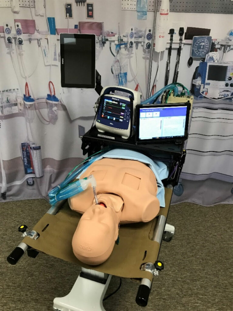 The initial proof-of-concept prototype included a realistic torso equipped with a lung model, upper airway, and head. Reproducible computerized algorithms simulated respiratory distress.